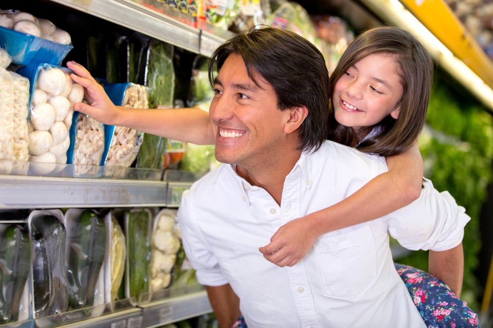 Father and daughter buying groceries at the supermarket